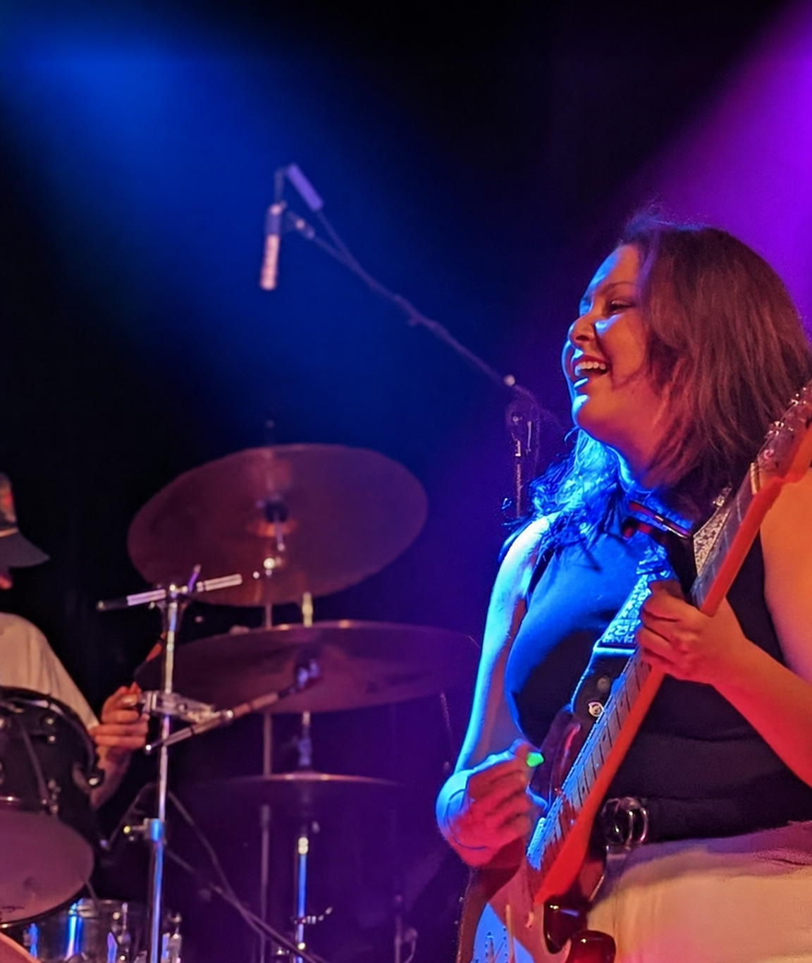 Mandy Moon performing live with guitar on stage